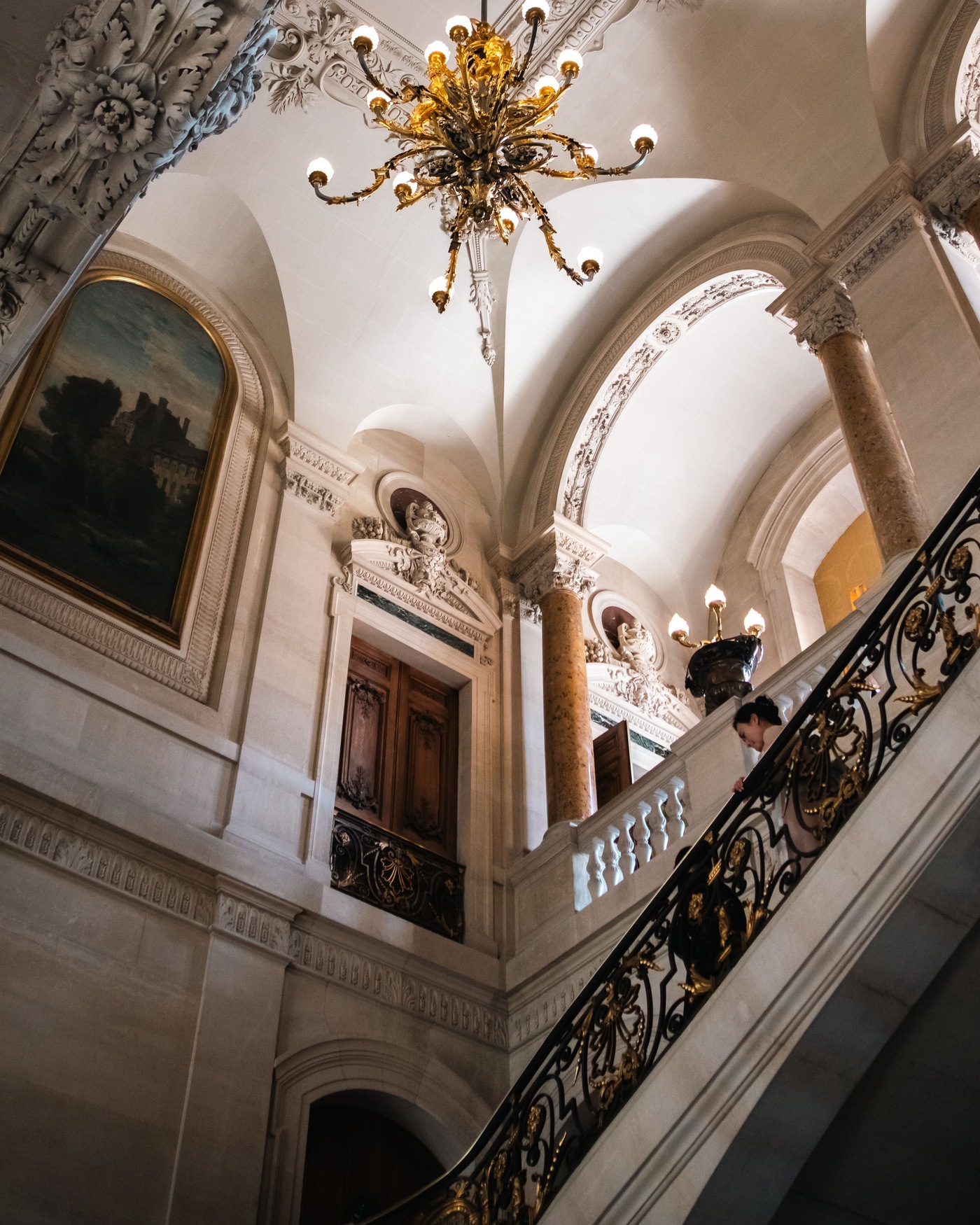 A stone staircase and gilt balustrade in a nineteenth-century Paris house.